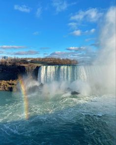 a rainbow in the middle of a waterfall