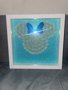 a white frame with a blue butterfly on it