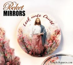 a button with the image of jesus surrounded by pink flowers and text that reads pocket mirrors look into christ