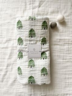 a white sheet with green trees on it