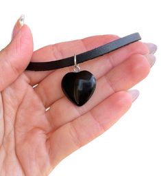 Obsidian Necklace - Leather Necklace - Black Obsidian - Obsidian Pendant - Black Crystal - Crystal Heart - Obsidian Heart - Evil Eye Stone Natural Obsidian heart shaped pendant with genuine leather ( 4mm, flat ) Available lengths: 14 inch / 35 cm 15 inch / 38 cm 16 inch / 40 cm  17 inch / 43 cm  18 inch / 45 cm Crystal characteristics and properties: Obsidian: Is associated with the Base Chakra The Obsidian is a volcanic glass, which has the ability to lead us to truth and clarity in order to fi Black Heart-shaped Jewelry Gift, Black Heart-shaped Jewelry For Gifts, Black Heart Charm Pendant Jewelry, Black Pendant Necklaces With Heart Charm, Black Heart-shaped Gemstone Jewelry, Black Pendant Necklace With Heart Charm, Black Pendant Jewelry With Heart Charm, Black Heart Beads Pendant Necklace, Black Heart Beads Jewelry For Valentine's Day