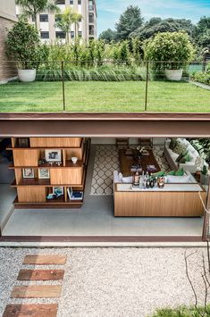 an overhead view of a living room and kitchen area in a house with grass on the roof