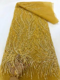 Gold Beaded Embroidered Fabric For Party, Gold Beaded Sequin Fabric For Wedding, Gold Beaded Lace Embroidered Fabric, Yellow Embroidered Fabric With Intricate Details For Party, Yellow Fitted Embroidered Fabric For Wedding, Fitted Yellow Embroidered Fabric For Wedding, Gold Embroidered Fabric With Rhinestones For Party, Sequins Fabric For Wedding And Festive Occasions, Fitted Gold Embroidered Beaded Fabric