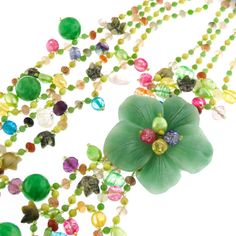 "Green Oasis Flower Gemstone 925 Sterling Silver Art Necklace Pictures cannot do justice to the rich opulence of this necklace. The centerpiece is a stunning flower cut out of solid aventurine. The necklace strap is richly beaded composition of cultured pearls and gemstones. Finished with 925 sterling. This necklace is a work of art. Pendant Size: 2 1/2\" flower Gemstone Type: Aventurine, carnelian, crystal Lock Type: Hook, 925 silver Necklace Size: 30\" Necklace Weight: ~11oz Price: 76.95" Elegant Flower Pendant Necklaces With Natural Stones, Green Gemstone Flower Pendant Jewelry, Green Gemstone Flower Pendant Necklace, Green Gemstone Flower Pendant Necklaces, Handmade Jade Necklace With Flower Pendant, Handmade Jade Flower Pendant Necklace, Elegant Flower Shaped Jade Jewelry, Green Gemstone Flower-shaped Jewelry, Green Gemstone Flower Shaped Jewelry