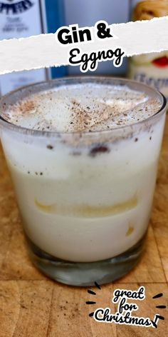 a close up of a drink in a glass on a table with the words gin & eggnog above it