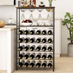 a wine rack filled with lots of bottles next to a potted plant in a kitchen