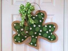 a green and white shamrock door hanger with polka dots on it's side