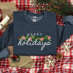 Happy Holidays Christmas Sweatshirt, Holiday Sweatshirt, Festive Sweatshirt, Ladies Crewneck Sweatshirt, Ugly Christmas Sweater, Xmas shirt The collar is ribbed knit, so it retains its shape even after washing. There are no itchy side seams on these sweaters.  .: 50% cotton, 50% polyester .: Medium-heavy fabric (8.0 oz/yd² (271.25 g/m .: Loose fit .: Sewn-in label .: Runs true to size *Please double check size chart to ensure correct fit. **Note:  actual colour may vary slightly from your comput Christmas Holiday Crew Neck Sweater, Festive Holiday Crew Neck Sweater, Festive Holiday Sweater With Crew Neck, Festive Long Sleeve T-shirt For Holiday, Festive Long Sleeve Holiday T-shirt, Festive Christmas Crew Neck Sweatshirt, Festive Holiday Crew Neck Sweatshirt, Holiday Crew Neck Sweater As Gift, Holiday Crew Neck Sweater As A Gift