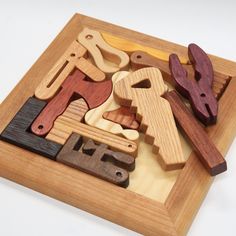 wooden toys are arranged in a square on a white surface, including hammers and wrenches