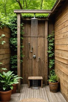 an outdoor shower with wooden walls and plants