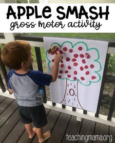 a young boy standing in front of an apple tree with the words apples smash gross motor activity