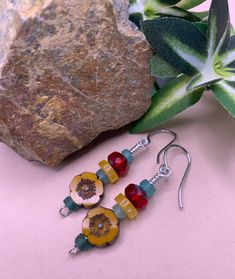 Golden yellow hibiscus flower beads, berry red facet cut beads, golden agate spacers, and Roman glass heishi beads make these very colorful earrings. Striking and eye catching, a great pair for any occasion. Yellow Hibiscus Flower, Red Bead Earrings, Bead Dangles, Yellow Hibiscus, Roman Glass, Daisy Earrings, Flower Beads, Hibiscus Flower, Colorful Earrings