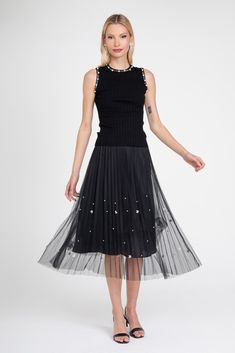 Get ready to dazzle in our Black Pearl Pleated Skirt! This midi skirt features a unique black tulle pleated design and is fully lined for comfort. With ivory pearls scattered all over and an elastic waistband, this versatile skirt is perfect for any occasion. Step out in style with this playful and eye-catching piece. Spring Evening Skirt With Pleated Hem, Spring Evening Tiered Pleated Skirt, Chic Evening Pleated Tulle Skirt, Party Tiered Skirt With Accordion Pleats, Midi Party Skirt With Accordion Pleats, Party Midi Skirt With Pleated Hem, Summer Evening Skirt With Pleated Hem, Spring Party Skirt With Pleated Hem, Spring Stretch Embellished Skirt