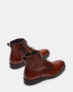 1.25 inch heel height 10.25 inch shaft circumference 5.75 inch shaft height Leather upper material Leather lining Leather sock Rubber sole Imported Steve Madden Store, Ankle Boots Men, Apparel Merchandising, Leather Socks, Men's Boots, Leather And Lace, Tan Leather, Boots Men, Rubber Sole