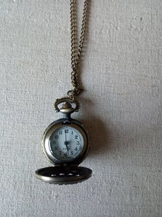 Pretty necklace style antique bronze coloured, filigree battery operated watch with blue lace agate accented chain.  Great for steampunk/victoriana as well as anyone who wants that something a little different.  The watch face is approx 1 inch diameter and the  chain measures approx 32 inches. Antique Gold Metal Pocket Watch, Antique Bronze Metal Pocket Watch, Antique Metal Pocket Watch Nickel Free, Vintage Metal Pocket Watch Nickel Free, Vintage Metal Pocket Watch With Chain, Pretty Necklace, Filigree Necklaces, Pretty Necklaces, Pocket Watches