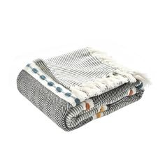 two blankets folded on top of each other, one with a blue and white pattern