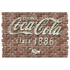 an old coca cola sign on a brick wall