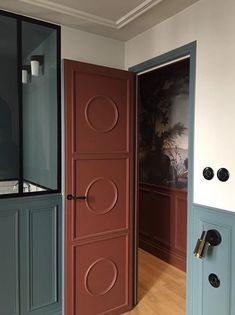 an open door leading to another room with paintings on the walls and wood flooring