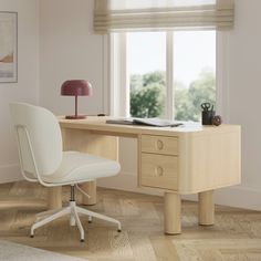 an office desk with a chair, lamp and pictures on the window sill in front of it