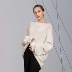 The versatile, luxurious, and elegant silhouette of the sweater ASTRID can be a part of many different looks, at the same time keeping you warm and cosy.  Hand-crafted from premium alpaca and mohair blend, this fluffy pullover features an oversized fit, raglan shoulder construction and extra-long sleeves. Style with jeans for a more casual look, or elegant trousers/skirt for an evening. DETAILS -Oversized -Boat neck -Extra-long puff sleeve -Raglan shoulder construction Designed and ethically mad Chic Balloon Sleeve Sweater For Winter, Elegant Knitted Winter Sweater, Winter Sweater With Balloon Sleeves In Soft Knit, Winter Soft Knit Sweater With Balloon Sleeves, Slouchy Chic Sweater, Oversized Elegant Sweater For Fall, Elegant Oversized Sweater For Fall, Chic Slouchy Sweater, Elegant Oversized Fall Sweater