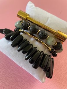 Gemstone Significance: Black Obsidian: Known for its grounding and protective properties, black obsidian helps to shield against negativity and promote emotional balance. Dalmatian Jasper: This unique stone is believed to bring a sense of playfulness and joy, encouraging a positive outlook and a sense of harmony. Versatile Style: The Obsidian & Jasper Bracelet Set is perfect for adding a touch of elegance and sophistication to any outfit. Whether you're dressing up for a special event, adding flair to your everyday look, or seeking a meaningful gift, these bracelets are a versatile and stylish choice. Description: Enhance your jewelry collection with the Obsidian & Jasper Bracelet Set. Handcrafted by skilled artisans, this set features four stunning bracelets made with black obsidian and d Onyx Gemstone Beads Bracelets For Meditation, Spiritual Onyx Bracelets For Gift, Elegant Obsidian Bracelets For Meditation, Spiritual Onyx Bracelets As Gift, Onyx Bracelets With Gemstone Beads For Meditation, Onyx Bracelets With Natural Stones For Gift, Onyx Bracelets With Natural Stones As Gifts, Black Hematite Jewelry For Meditation, Modern Black Bracelets With Black Beads