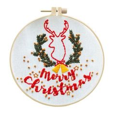 a white embroidered christmas ornament with a red ribbon and reindeer's head