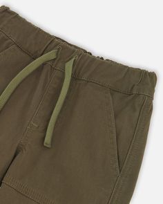 These stretch twill jogger pants are the perfect combination of comfort and style. Made from durable twill fabric, these pants have two cargo pockets for increased storage. Perfect for everyday wear or a night out. Adjustable Waist Cotton Pants With Pockets, Cotton Bottoms With Side Pockets And Adjustable Waist, Cotton Khaki Cargo Pants With Elastic Waistband, Adjustable Waist Cotton Bottoms, Cotton Bottoms With Adjustable Waist, Utility Cotton Cargo Pants With Pull-on Style, Cotton Solid Color Pull-on Joggers, Solid Cotton Pull-on Joggers, Stretch Cotton Pants With Multiple Pockets