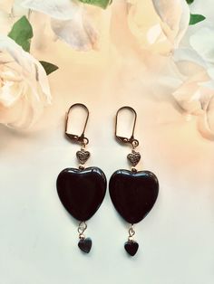 Black heart earrings--Triple hearts! These black hearts have gold hearts above them and smaller black hearts that dangle from below. Perfect for a more dramatic look or those days when only a black heart will do.  Length: 2.5 inches