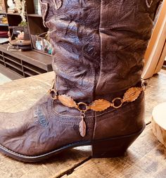 This beautiful copper boot bracelet features oval shaped links with western inspired embossed designs. it has copper feathers charm dangles.  It is finished with a copper chain, a star & large lobster claw clasp. It is upcycled from a copper belt. Total length is 16". This item is sold as a single.  This piece is designed with the bold woman in mind. Wear it to concerts, festivals or parties. Made in the USA. Return & Exchange Policy I will gladly accept returns or exchanges on items within 7 da Copper Belt, Jewelry Repurposed, Boot Bracelet, Boot Jewelry, Feather Charms, Bracelet Ideas, Copper Chain, Chain Link Bracelet, Lobster Claw