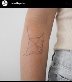 a woman's arm with a tattoo on it that is shaped like a star