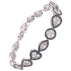 18K White Gold Diamonds: 9.41ct total weight. All diamonds are G-H/SI stones. Height - is approximately 1cm/0.40inches. Length - is approximately 18cm/0.99inches. Illusion Bracelet, New York Black And White, Bracelet Tennis, Modern Bracelets, Organic Forms, Tennis Bracelet, Real Diamonds, 925 Sterling Silver Jewelry, Diamond Gemstone