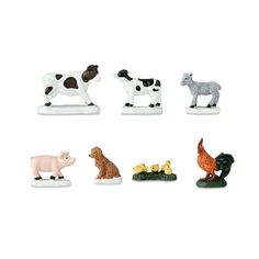 small plastic farm animals on white background