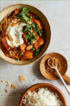 two bowls filled with food on top of a table