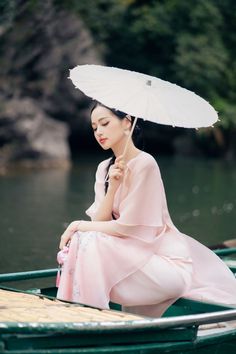 Elevate your style with our Ao Dai. This exquisite garment boasts an A-line silhouette and delicate cut-out detailing crafted from premium organza. Perfect for special occasions, its floor-length design adds drama and elegance. Make a statement and exude luxury with every step. Length: 115cm-115cm-117cm (S/M/L), Pants: 104cm-105cm-105cm (S/M/L) Elegant Spring Ceremony Gown, Organza Gown For Banquet, Organza Dresses For Ceremonies, Summer Wedding Ao Dai In Maxi Length, Mean Blvd, A Line Cut, Organza Fabric, Ao Dai, Lunar New