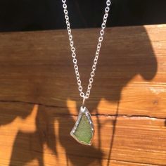 This genuine green sea glass necklace is the perfect way to accessorize any outfit, and makes a great gift! Made from one piece of GENUINE green sea glass tumbled naturally by the ocean, and soldered to complete the look Every purchase will INCLUDE an 18" necklace chain as seen in the photos.  Perfect way to carry a little piece of the ocean with you wherever you go!   Ships FREE to the US with purchase of $35 or more from our shop! Please note that these necklaces are individually handmade, and Handmade Green Sea Glass Necklace, Green Recycled Glass Jewelry For The Beach, Green Recycled Glass Beach Jewelry, Recycled Glass Green Jewelry For Beach, Beach Glass Necklace, Light Sun, Sea Jewelry, Jewelry Beach, Sea Glass Pendant