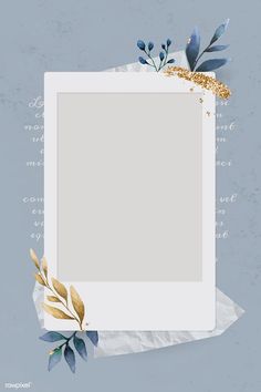 an empty photo frame surrounded by blue leaves and gold glitters on a gray background