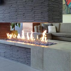 an outdoor fire pit in the middle of a living room