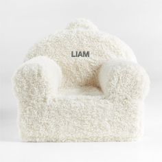 a white chair with the word llama on it's back and arms, sitting in front of a white background