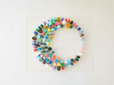 a circle made out of colored circles on a white surface