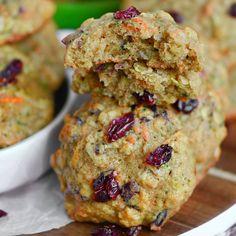 three cookies stacked on top of each other with cranberries in the middle and another cookie behind them