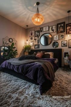 a bedroom with pictures on the wall and a large bed in front of a mirror