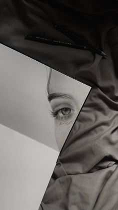 a black and white photo of a woman's face with eyeliners on it