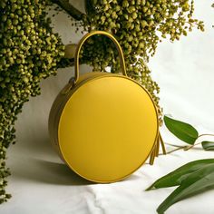 "A round tote  bag  with a handle will help to emphasize your femininity, it will always effectively emphasize your image and will help to free your hands from the little things that always clutter up your pockets. The leather work tote bag not only complements your style, but also becomes a roomy bag for every day, work or walk. The yellow color of the skin, the quality of work, the silhouette of the bag are created for a true connoisseur of beauty. Product information:  *Italian leather  * ski Chic Round Case Bag For Gift, Travel Bag With Detachable Handle And Round Case, Leather Bags With Round Handle For Gifts, Trendy Satchel With Round Handle For On-the-go, Leather Shoulder Bag With Detachable Handle In Round Shape, Round Shoulder Bag For Travel, Leather Shoulder Bag With Detachable Handle And Round Case, Trendy Bucket Bag With Top Round Handle, On-the-go Satchel With Round Handle