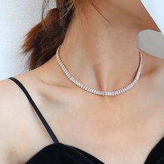 Elevate your neck game with this exquisite Tennis necklace, a stunning piece that exudes elegance and glamour. Meticulously crafted with high-quality stainless steel, this beauty ensures long-lasting durability and fade-free shine. Adorned with clear or green cubic zirconia stones, it glistens with an alluring sparkle that is sure to turn heads. The heavy layer of 18K gold adds a touch of luxury and leaves a thick layer to prevent any wearing off. With its perfect fit size of 41cm, this necklace Luxury Diamond Choker Necklace, Elegant Luxury Heavy Necklace, Luxury Gold Cubic Zirconia Choker, Luxury Sparkling Stones Choker Necklace, Luxury Gold Cubic Zirconia Tennis Necklace, Luxury Cubic Zirconia Tennis Necklace, Luxury Choker Necklace With Sparkling Stones, Luxury Cubic Zirconia Tennis Necklace With Sparkling Stones, Luxury Clear Necklace