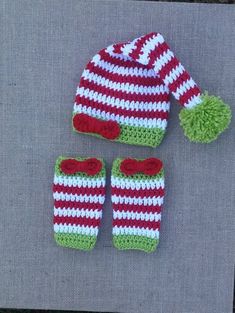 a crocheted hat, mittens and booties are sitting on a table