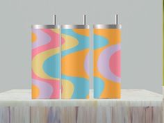 three colorful tumbles sitting on top of a table