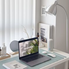 an open laptop computer sitting on top of a desk