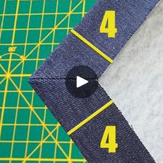 a close up of a piece of cloth with yellow numbers on it next to a ruler