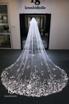 a wedding veil is shown in front of a storefront with the words, i amhistudio on it