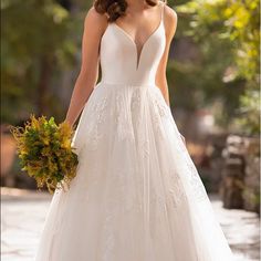 a woman in a wedding dress holding a bouquet